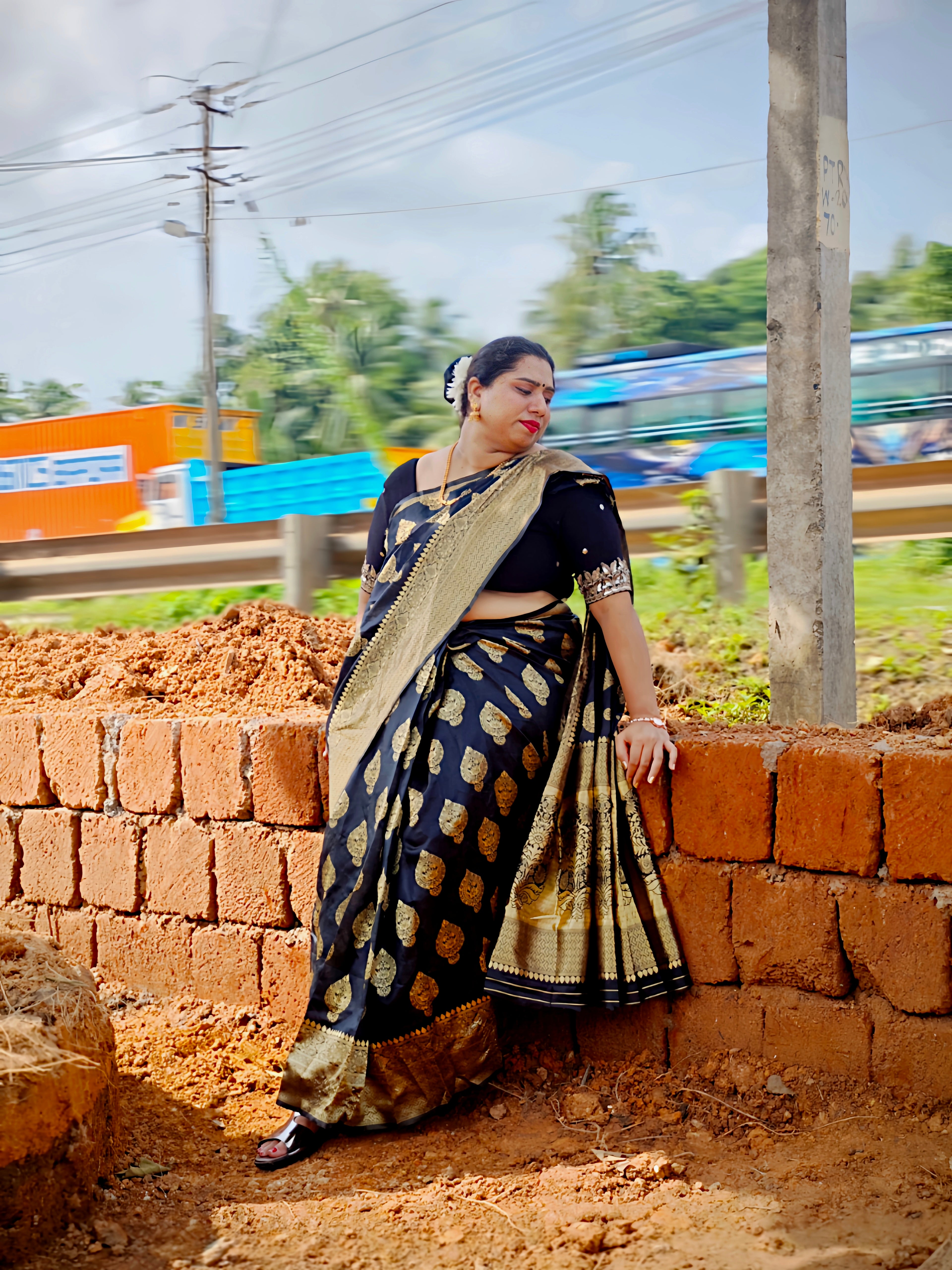 Model wearing a Black Banarasi Silk Saree with traditional zari woven mango buttas, elegant zari border, and matching running blouse by Vyra Fashion.