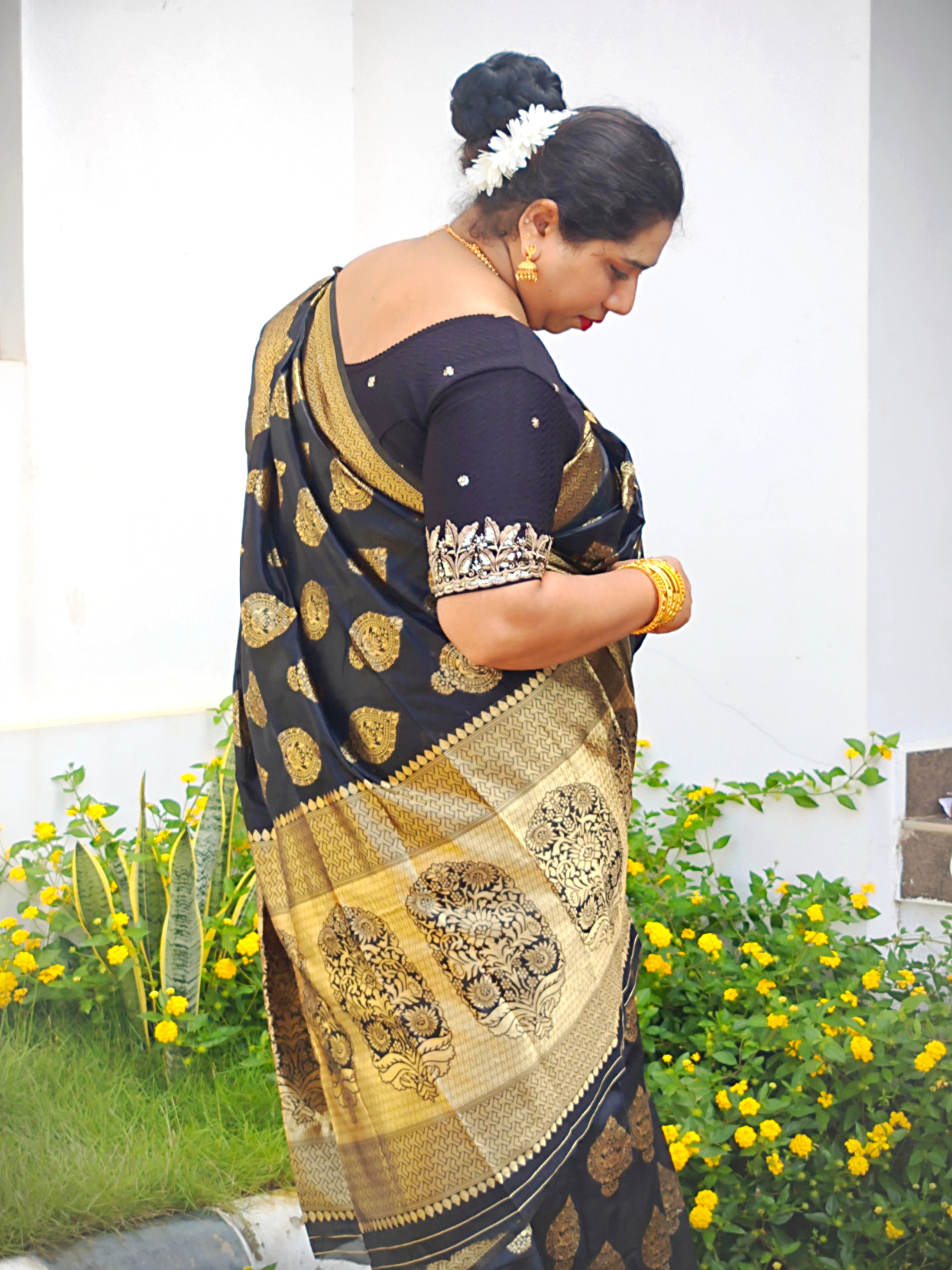 Close-up of the zari woven pallu on a Black Banarasi Silk Saree featuring intricate floral paisley (mango) motifs by Vyra Fashion.